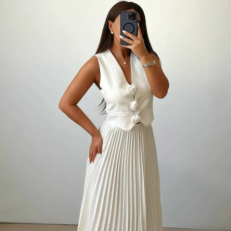Off-white two-piece set with pleated skirt and sleeveless buttoned top