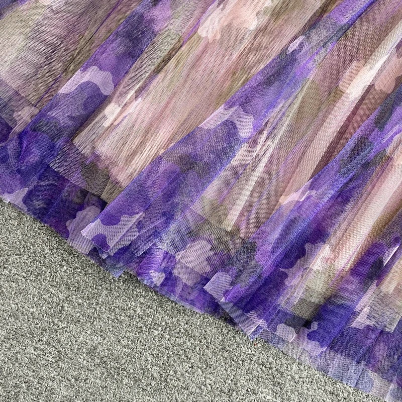 Purple V-neck top with ruffle sleeves and printed midi skirt